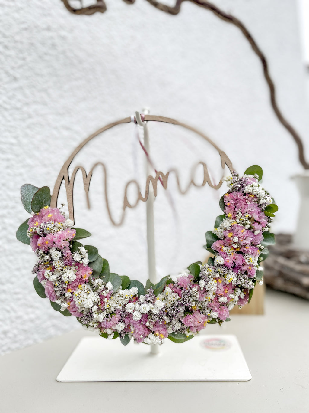 Laser-geschnittener Holzschriftzug „mama“ in Kombination mit natürlicher Eukalyptus- und Blütendekoration