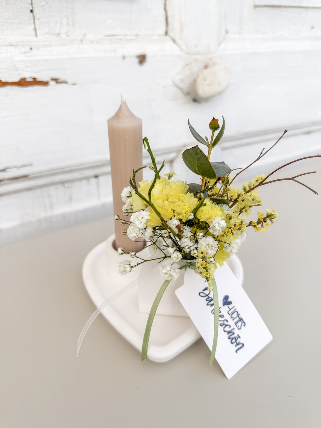 Raysinschale Herzform mit Stabkerze in cremebeige und farblich abgestimmtem Blumenbouquet in gelb